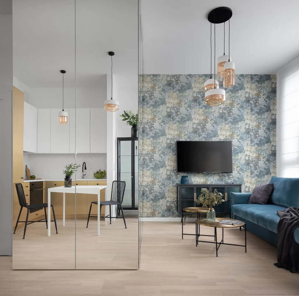 Kolorystyczne rozdzielenie przestrzeni salonowej i kuchennej daje mieszkaniu klarowną strukturę i zwiększa użytkowość wnętrza.